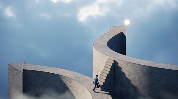 A businessman climbs a concrete staircase toward a platform pointing to a bright light in the sky.